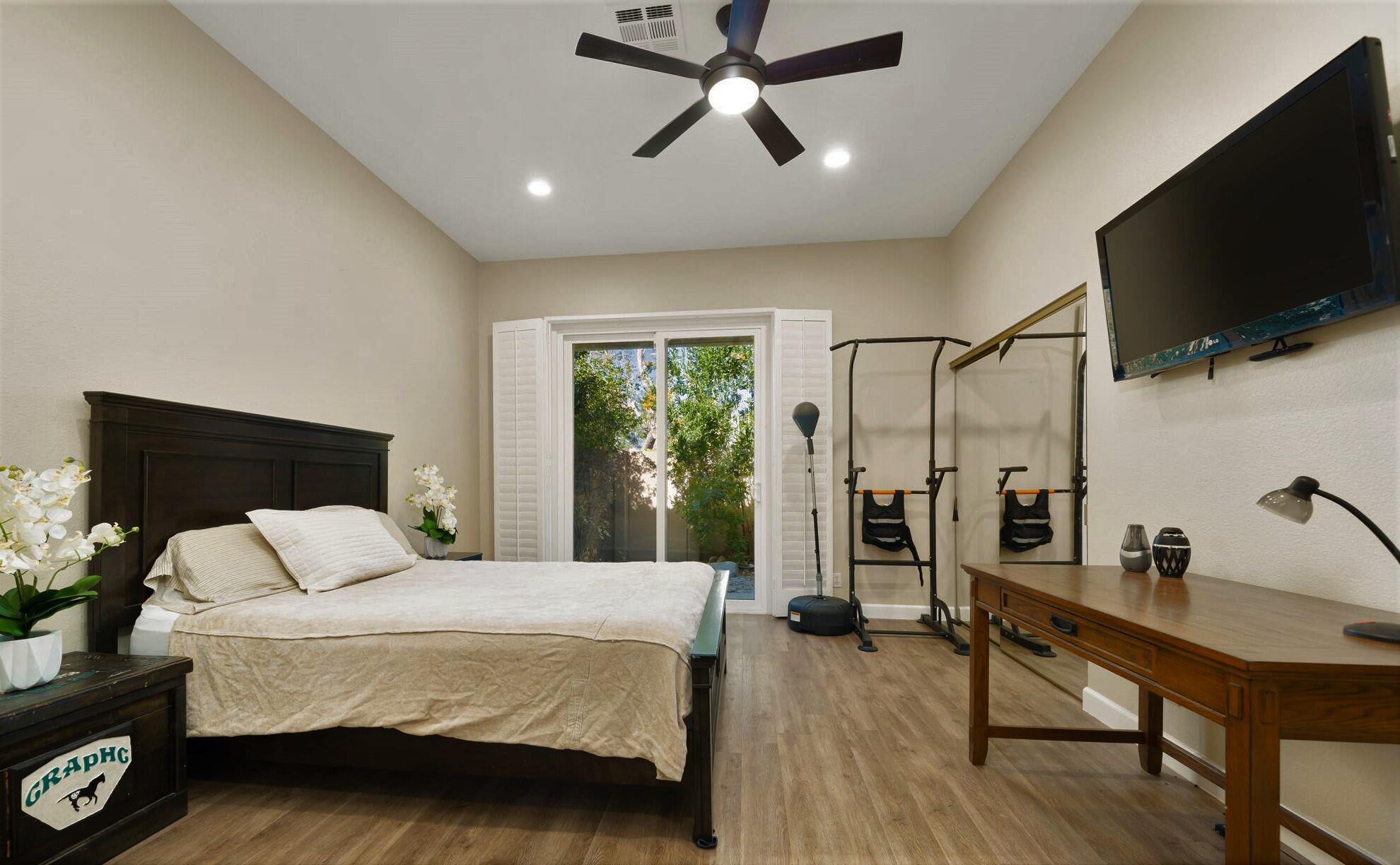 33 Colonial Drive Rancho Mirage, CA 92270 - Photo 31 of 62 a bedroom with a bed a large window and flat screen tv