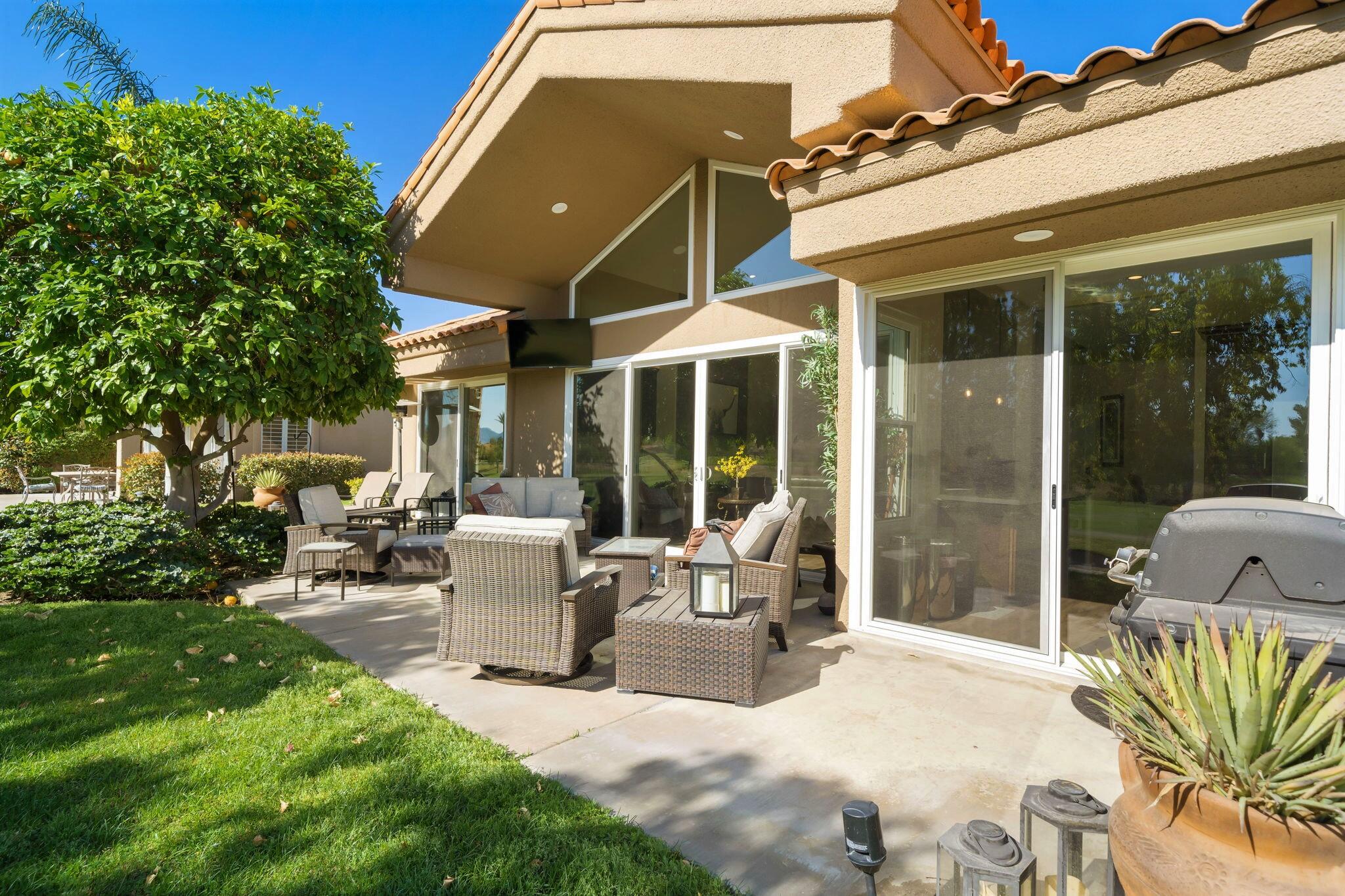 33 Colonial Drive Rancho Mirage, CA 92270 - Photo 41 of 62 a view of a patio with couches table and chairs and potted plants