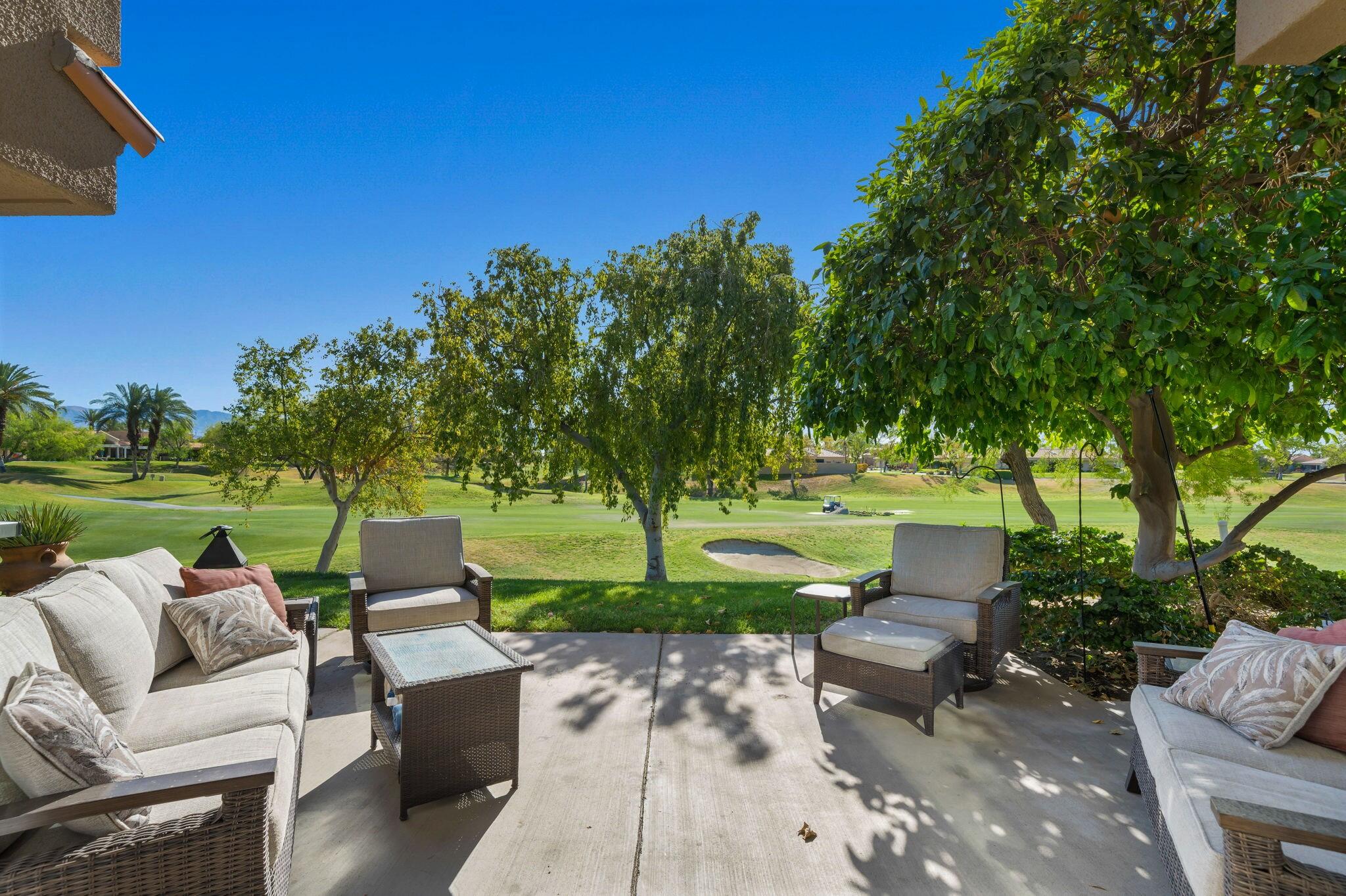 33 Colonial Drive Rancho Mirage, CA 92270 - Photo 43 of 62 a view of a patio with couches chairs and a big yard