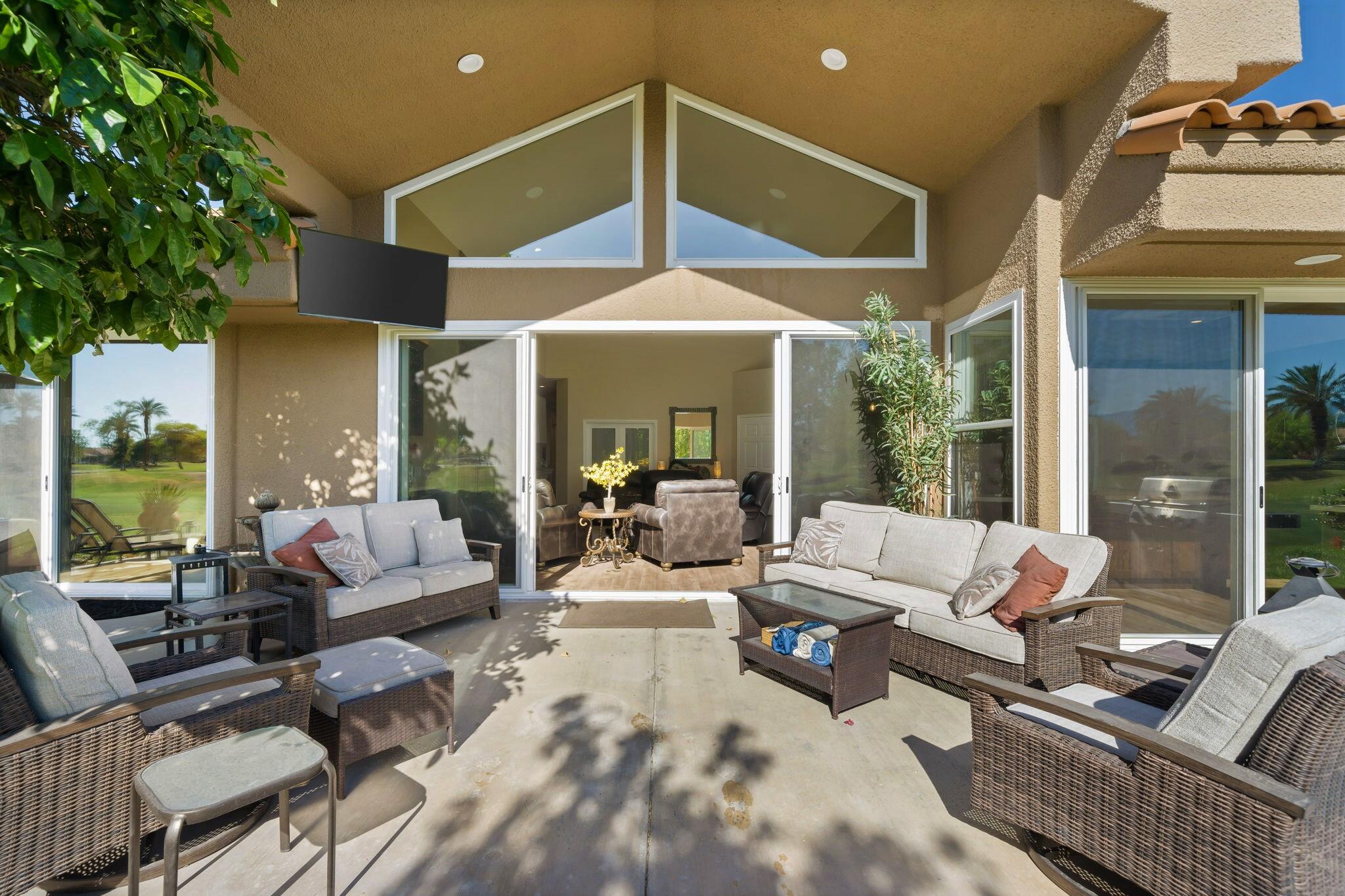 33 Colonial Drive Rancho Mirage, CA 92270 - Photo 44 of 62 a living room with furniture ceiling fan and a large window