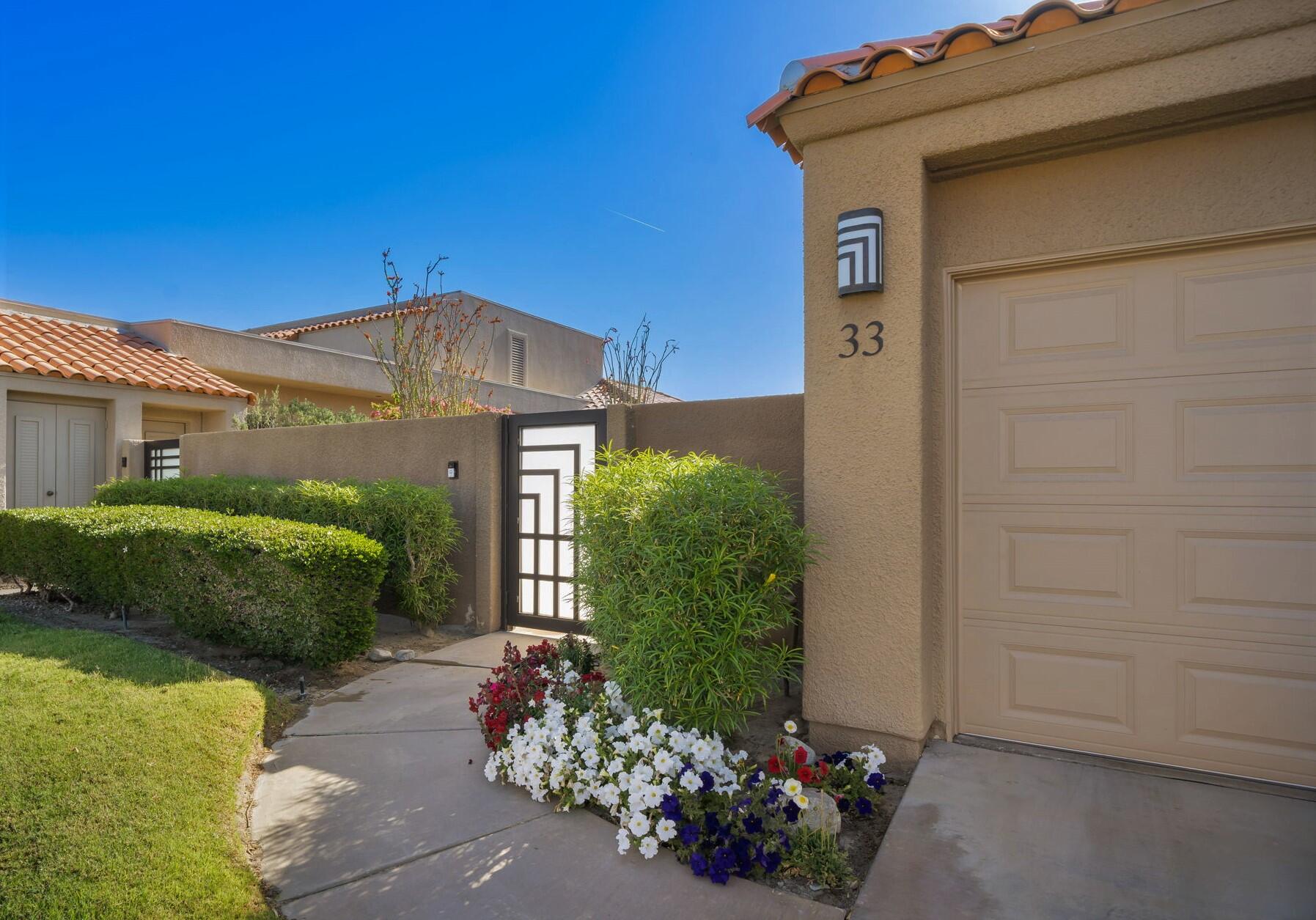 33 Colonial Drive Rancho Mirage, CA 92270 - Photo 49 of 62 a front view of a house with a yard