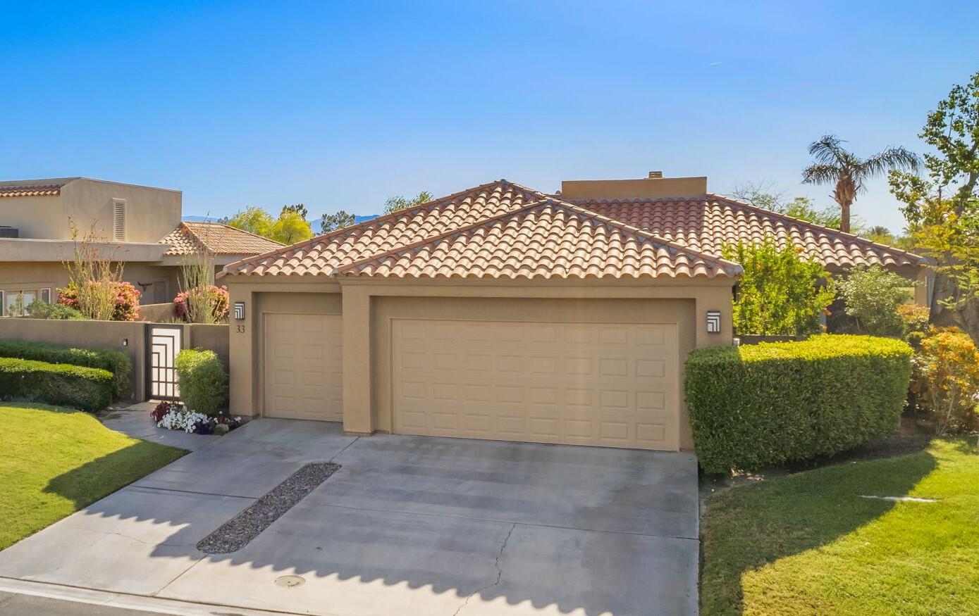 33 Colonial Drive Rancho Mirage, CA 92270 - Photo 50 of 62 a front view of a house with a yard
