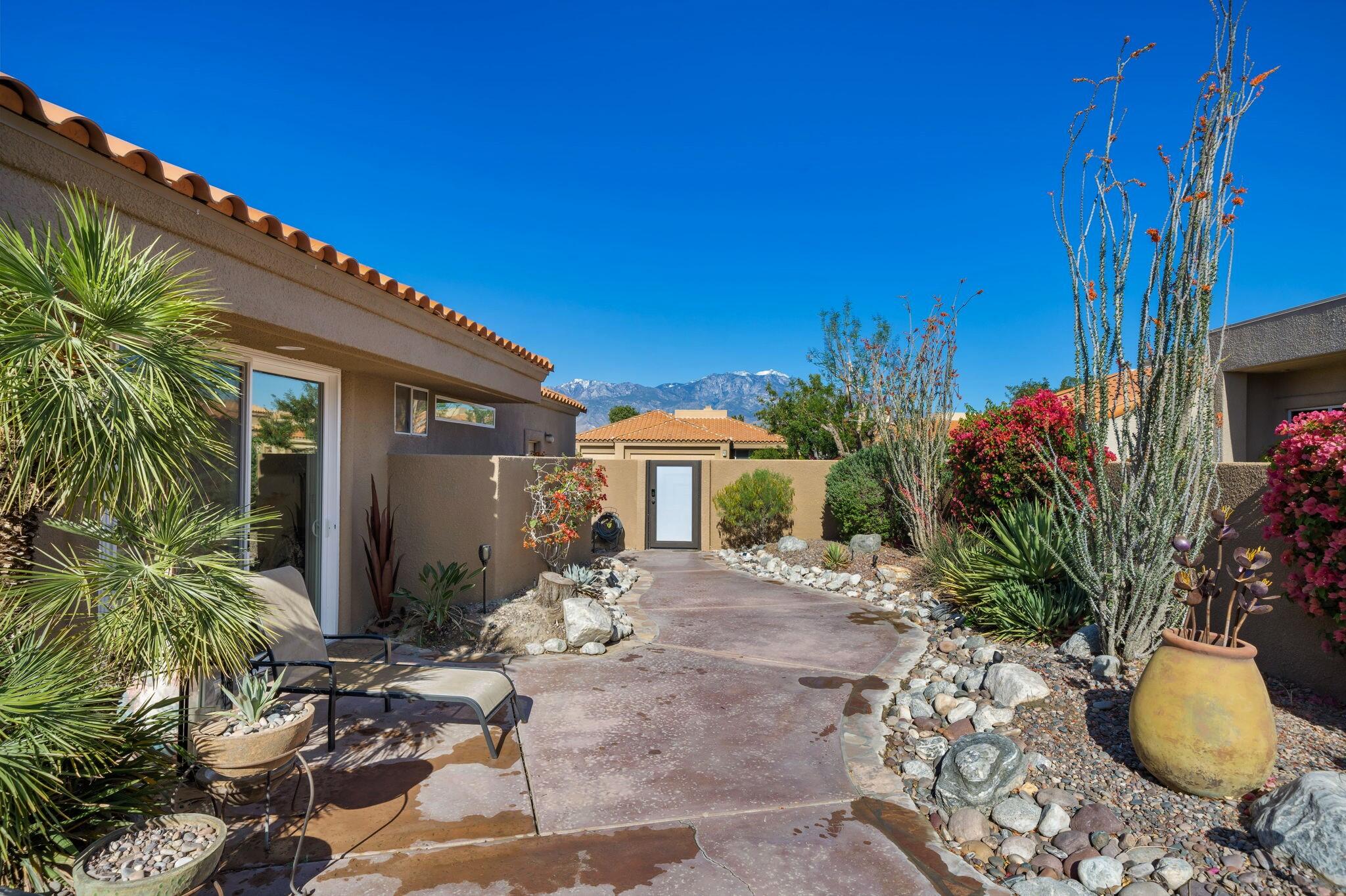 33 Colonial Drive Rancho Mirage, CA 92270 - Photo 51 of 62 a view of a patio with table and chairs potted plants with wooden fence