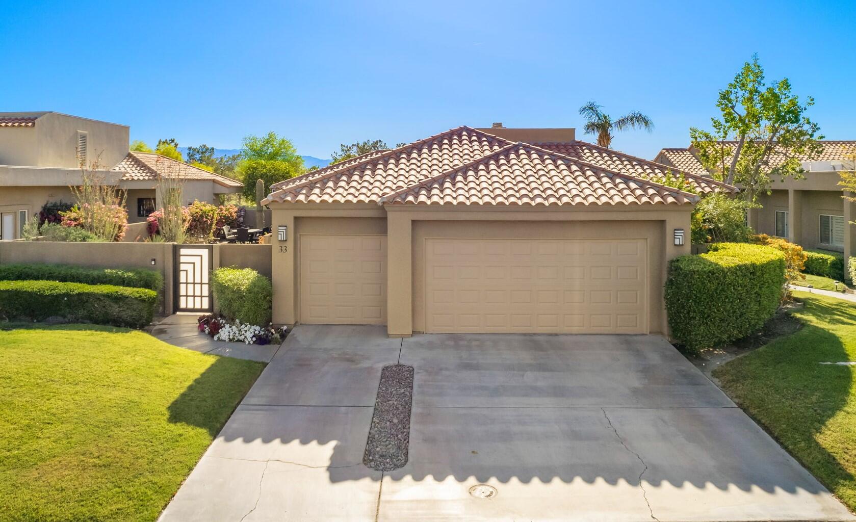 33 Colonial Drive Rancho Mirage, CA 92270 - Photo 61 of 62 a front view of a house with garden