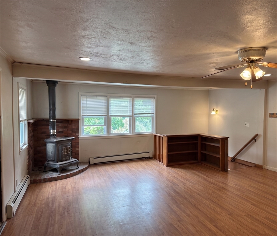 27 High Street Sturbridge, MA 01518 - Photo 3 of 17 wooden floor in an empty room with a window