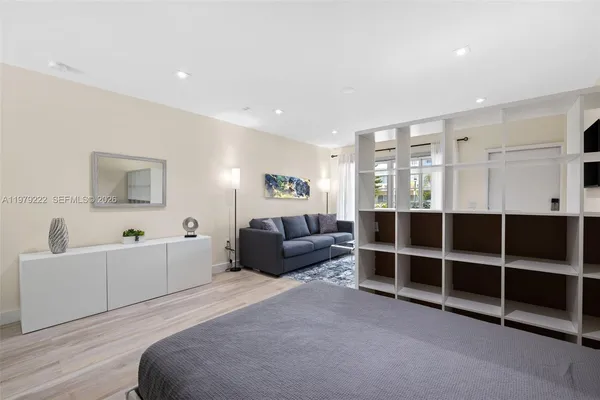 a living room with furniture and a bed