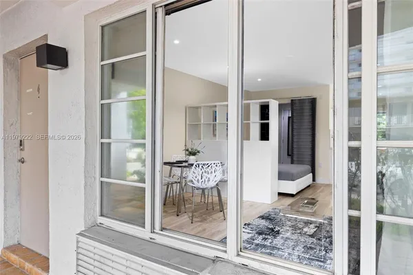 a bathroom with a glass shower door and a glass door