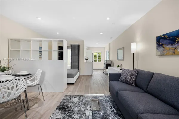 a living room with furniture and wooden floor