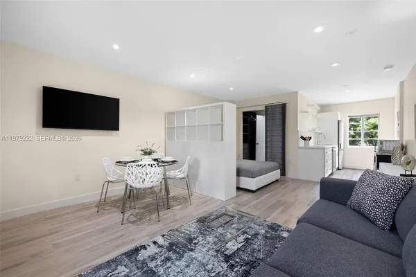 a living room with furniture and a flat screen tv