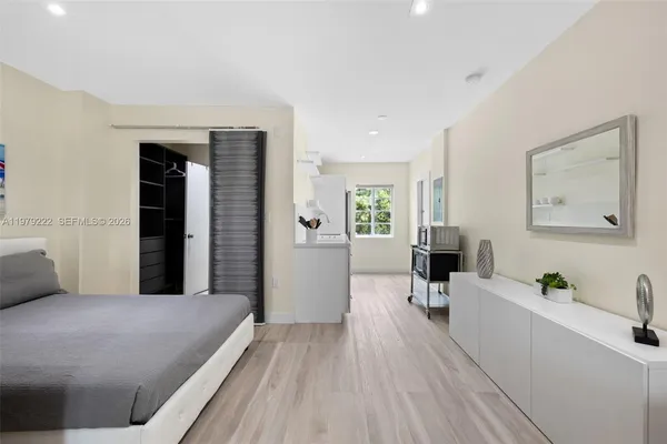 a bedroom with a bed and a couch