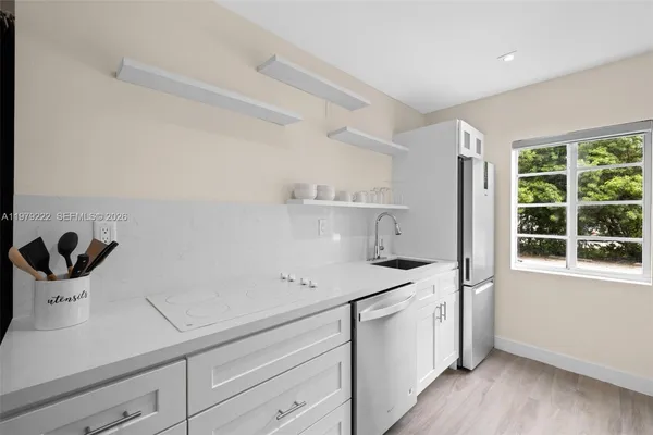 a kitchen with a sink and cabinets