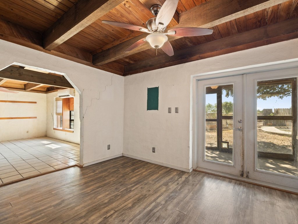 20416 Wilson Road Coupland, TX 78615 - Photo 20 of 39 Rich wood plank ceilings and exposed beams elevate this versatile living space.