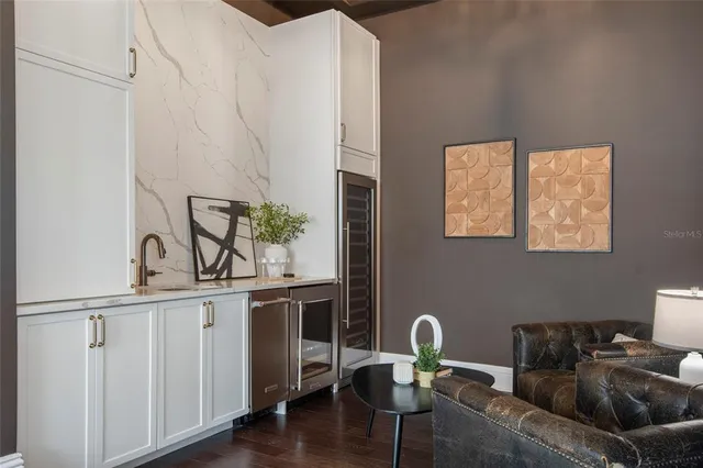 a kitchen with counter top space appliances and a view of living room