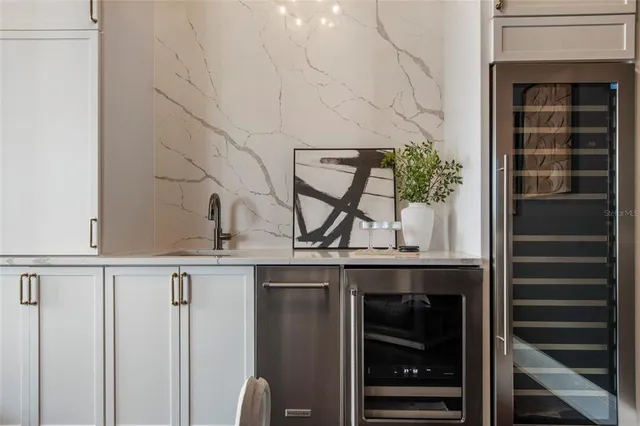 a living room with furniture kitchen view and a wooden floor