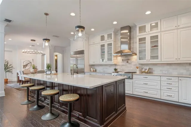 a view of a dining room with furniture and chandelier