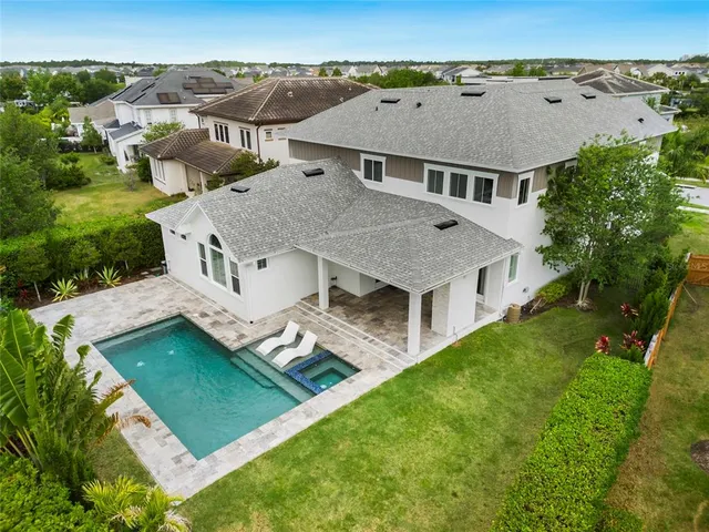 an aerial view of residential house with a yard