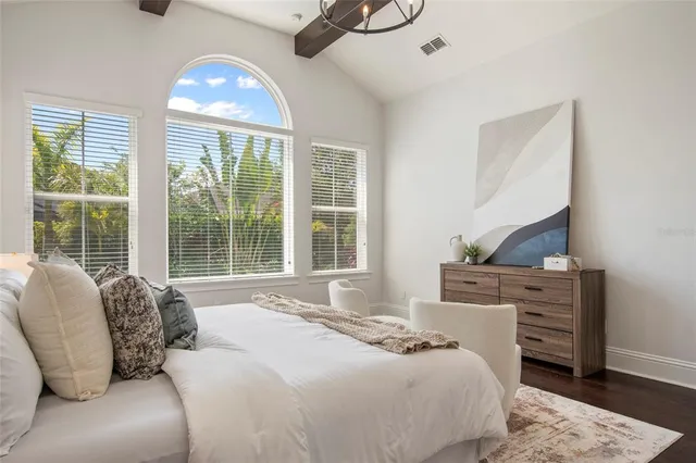 a bathroom with a tub a sink and mirror