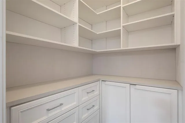 a view of an empty room with a fireplace and a floor to ceiling window
