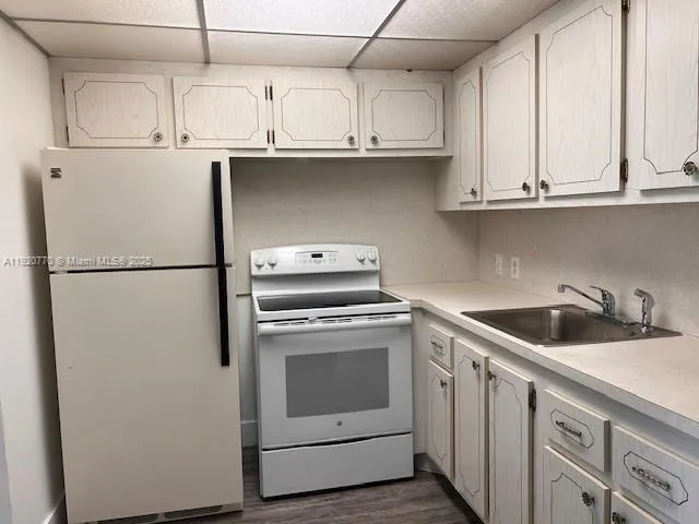 a kitchen with stainless steel appliances granite countertop a sink and a refrigerator