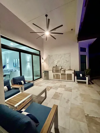 a living room with furniture kitchen view and a flat screen tv