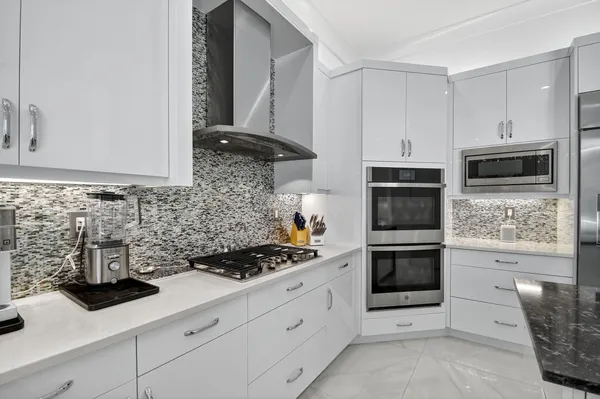 a bathroom with a granite countertop sink a mirror and vanity