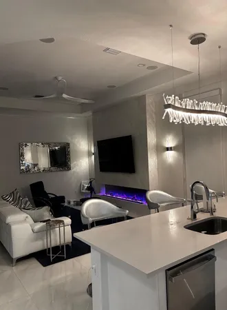 a view of a patio with table and chairs potted plants with floor to ceiling window