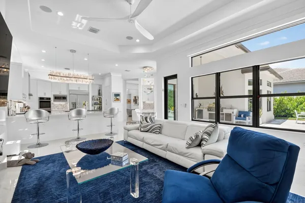 a living room with furniture kitchen and a table