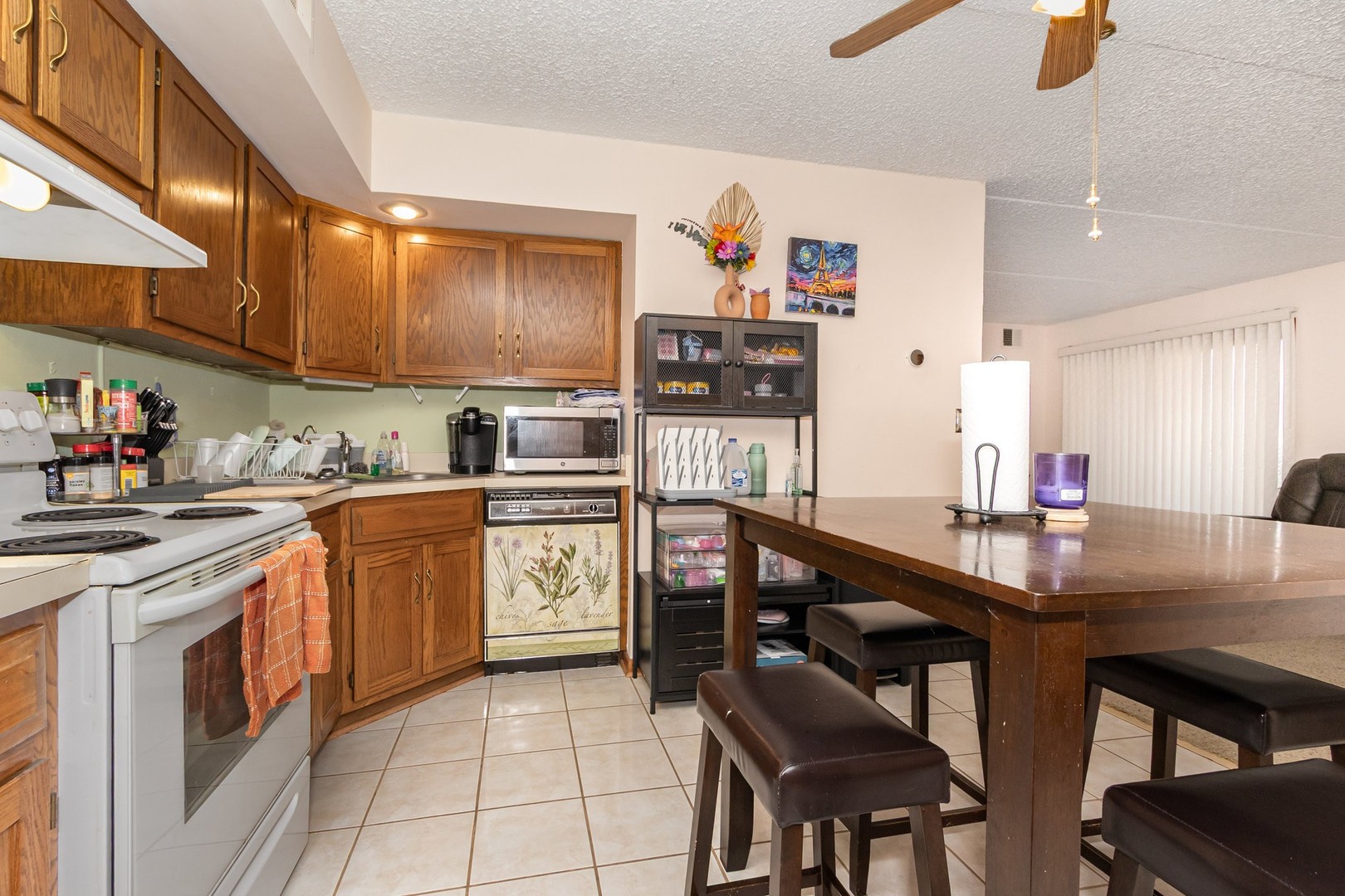 1472 Rock Run Drive, Unit 1B Crest Hill, IL 60403 - Photo 5 of 11 a kitchen with appliances cabinets and chair