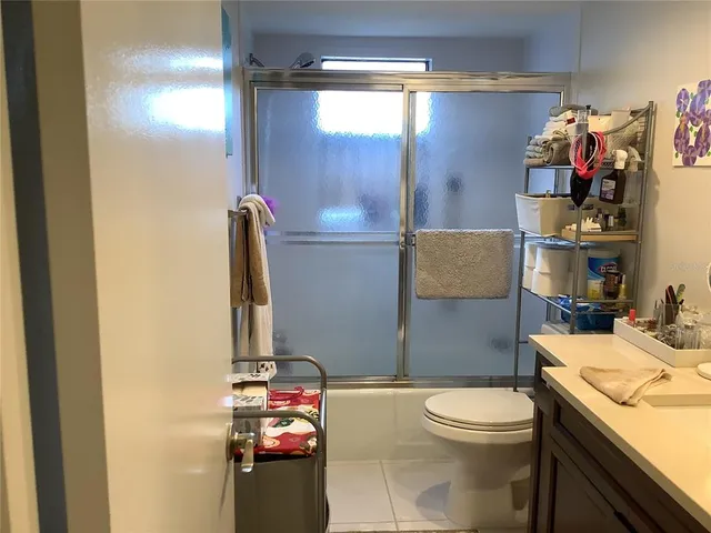 a view of a hallway and a livingroom with wooden floor