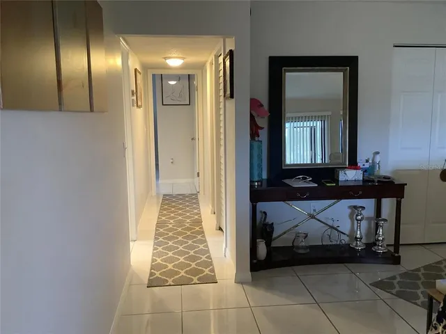 a kitchen with stainless steel appliances granite countertop a sink stove refrigerator and cabinets