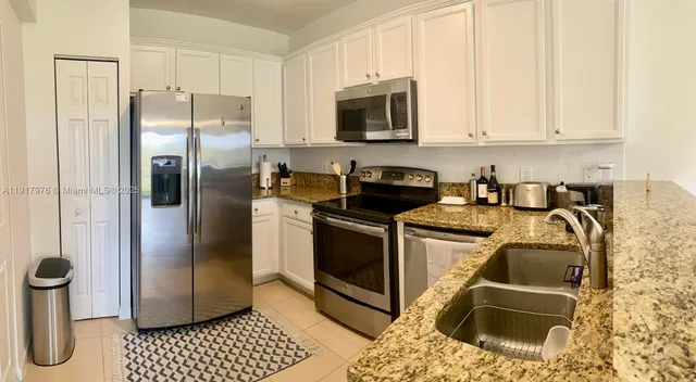 a kitchen with a refrigerator sink and microwave
