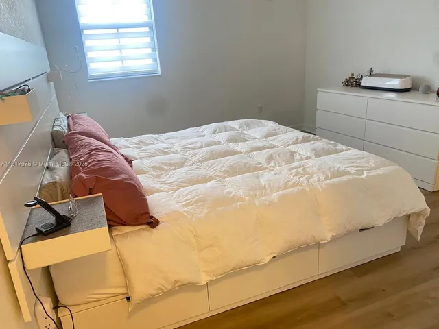 a bedroom with a bed and dresser