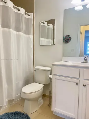a bathroom with a toilet sink and shower