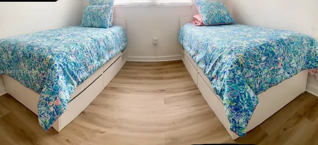 a bed sitting in a bedroom next to a staircase