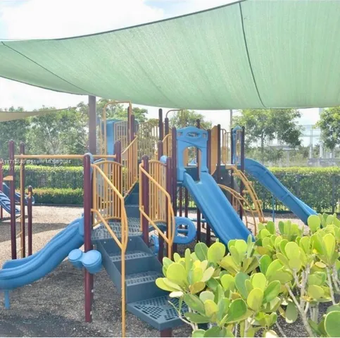a view of swimming pool with outdoor seating and plants