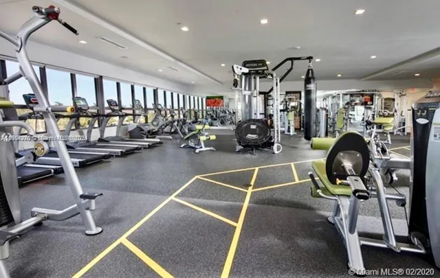 a living room with lots of furniture and kitchen view