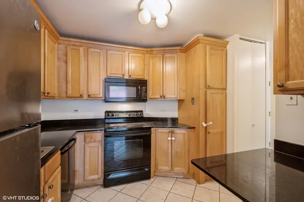 a kitchen with stainless steel appliances granite countertop a stove a refrigerator and a microwave