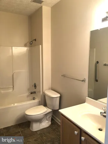 a bathroom with a toilet a sink and bathtub
