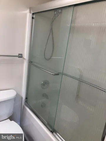 a bathroom with a shower and a toilet