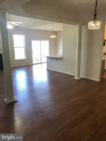 a view of a room with wooden floor and windows