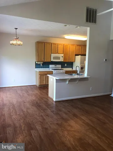 a kitchen with stainless steel appliances a stove top oven a sink and a window