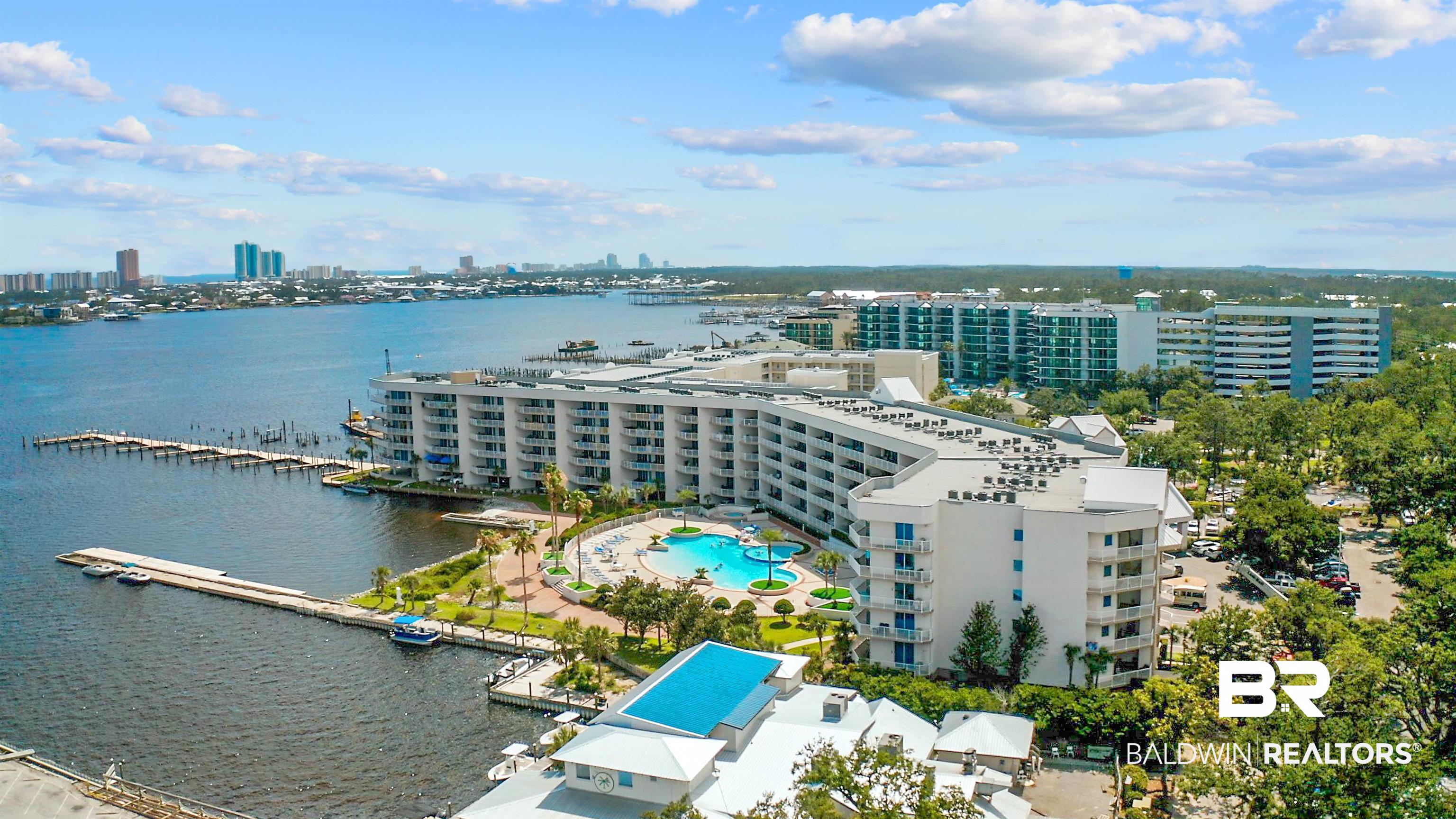 27800 Canal Road, Unit 113 Orange Beach, AL 36561 - Photo 31 of 35 View of urban area with a pool and a nearby body of water