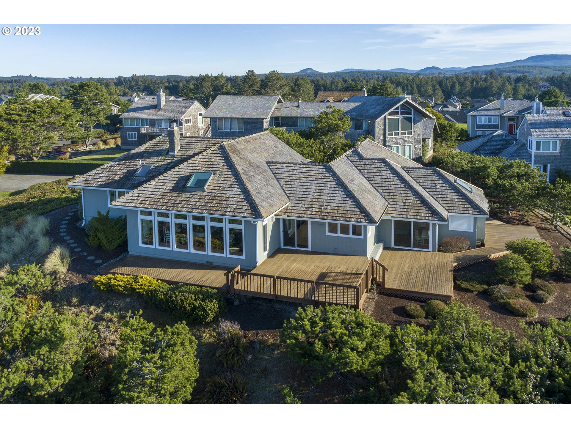 4750 High Ridge Road Gearhart, OR 97138 - Photo 8 of 28 an aerial view of a house with a big yard and large trees