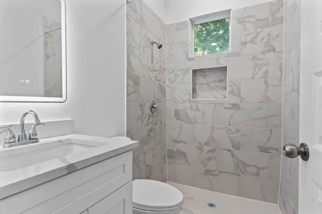 a view of a glass door with a balcony from a window