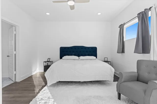 a bathroom with a granite countertop toilet and a sink