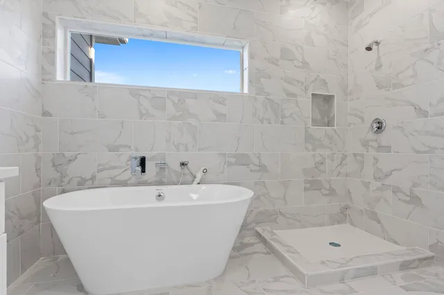 a bathroom with a sink a toilet a mirror and bathtub