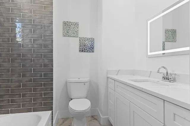 a bedroom with two beds and a table