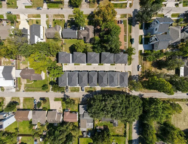 an aerial view of residential houses with city view