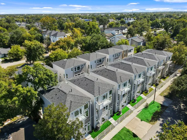 an aerial view of multiple houses with yard