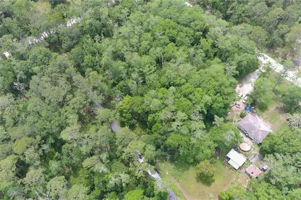 an aerial view of a house with yard